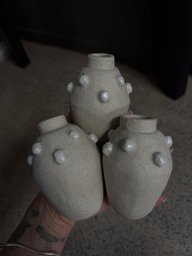 Three ceramic mini vases with textured surface and pearl style detailing.